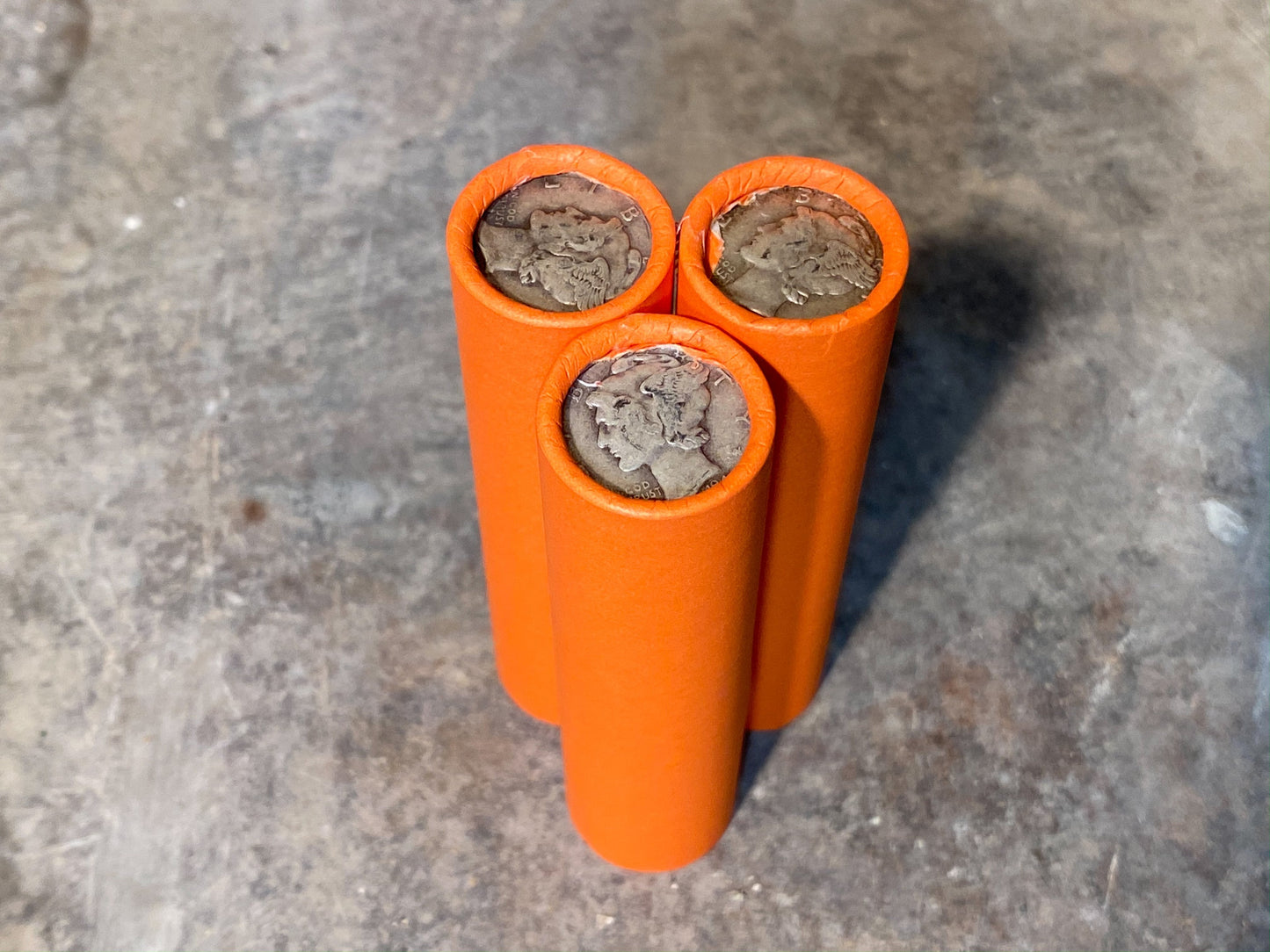 SILVER MERCURY DIME showing on end of orange unsearched old wheat penny roll us coins estate collection cent sale pennies lot hoard