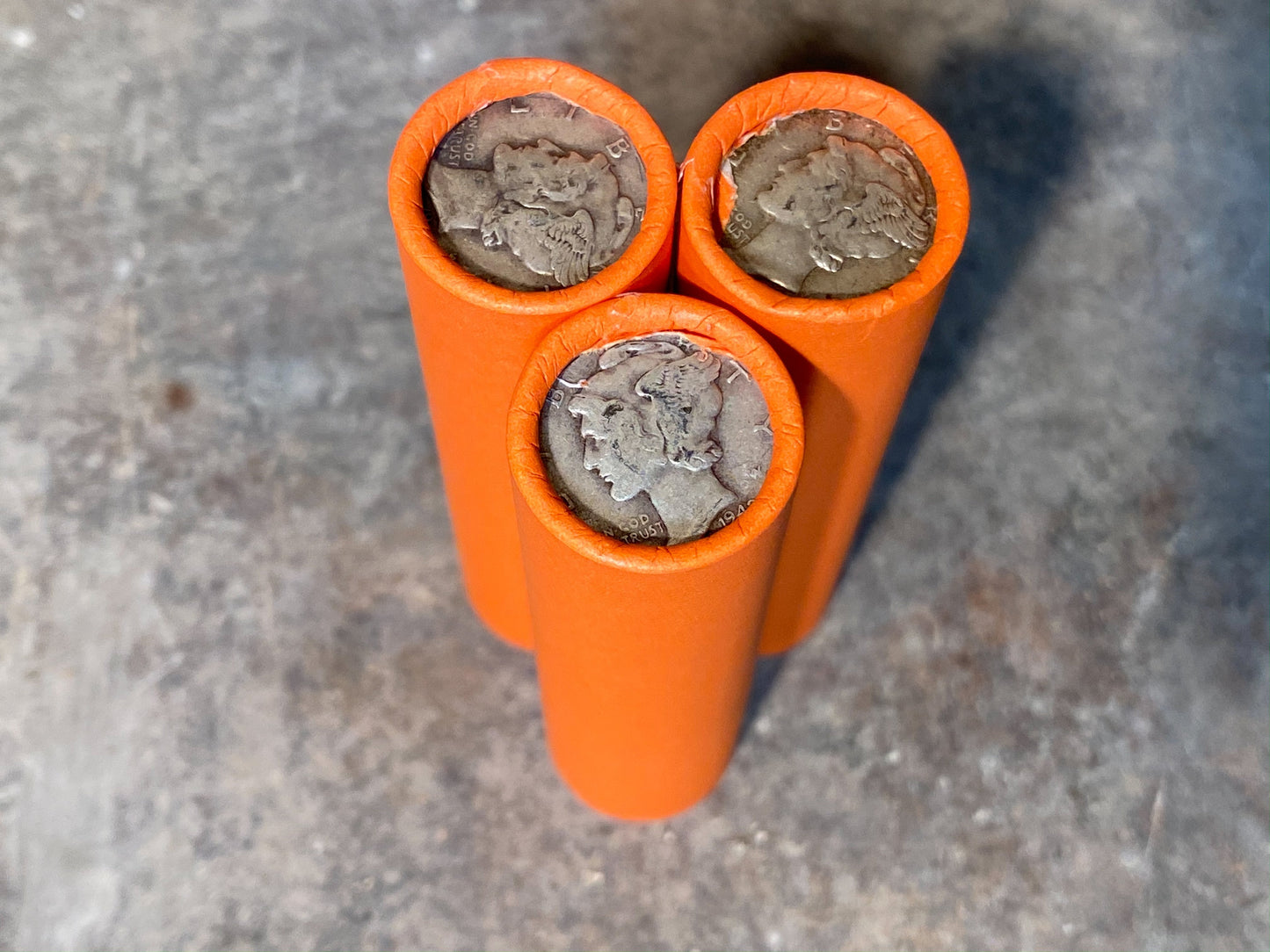 SILVER MERCURY DIME showing on end of orange unsearched old wheat penny roll us coins estate collection cent sale pennies lot hoard