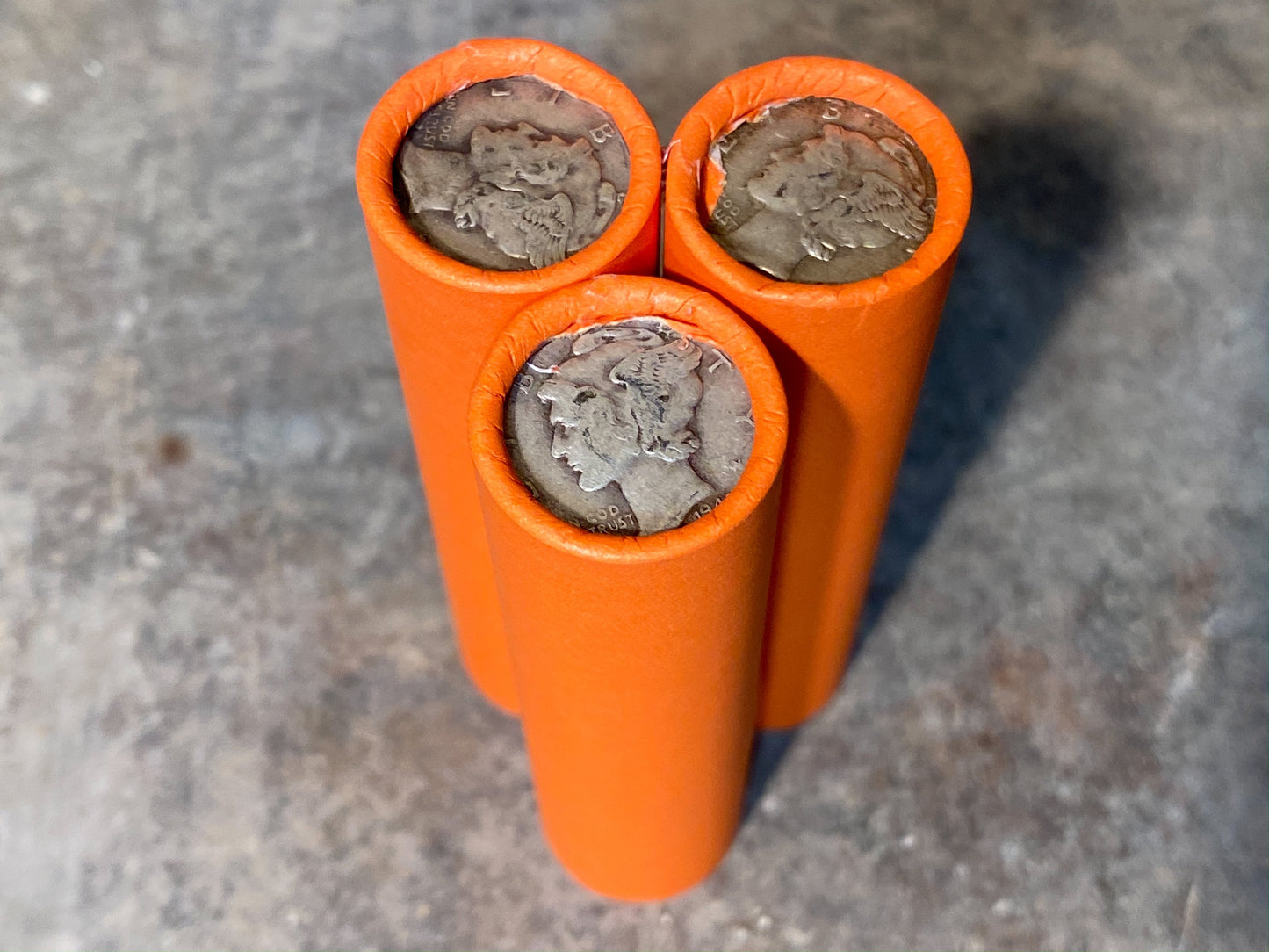 SILVER MERCURY DIME showing on end of orange unsearched old wheat penny roll us coins estate collection cent sale pennies lot hoard